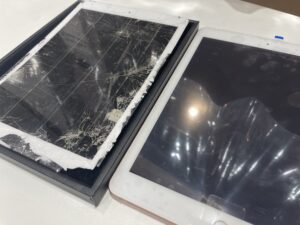 Severely cracked front glass on an iPad 8 before repair, with extensive damage spread across the entire screen
